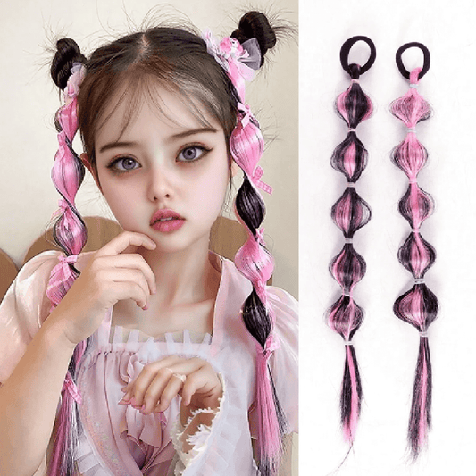 Child with pink and black hair extensions styled in pigtails, with two extensions displayed on the right.
