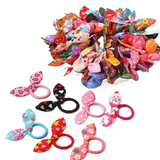 Colorful assortment of fabric hair ties with various designs on a white background