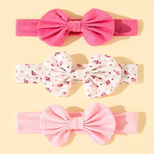 Three pink headbands with large bows