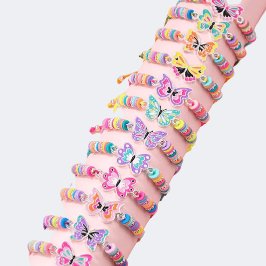 Colorful butterfly-themed bracelets on a person's wrist against a light pink background