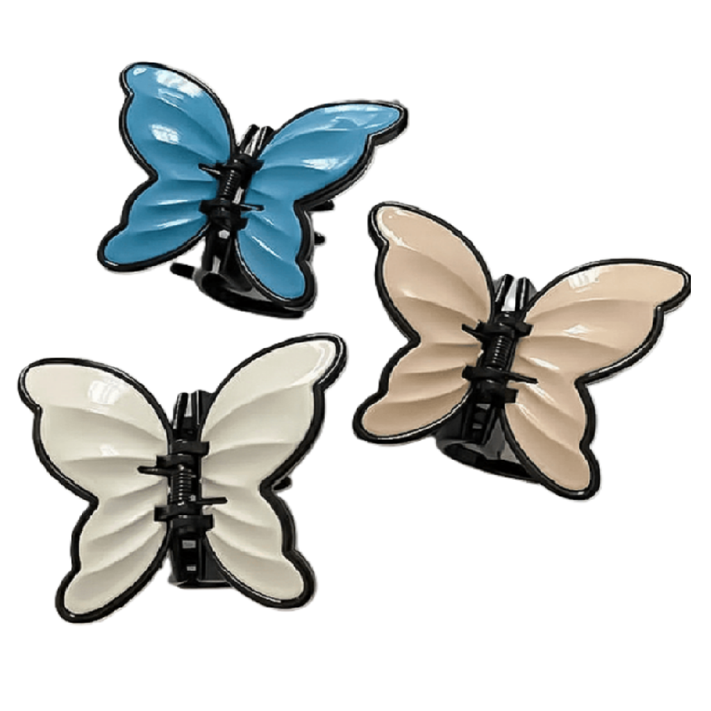 Three butterfly-shaped hair clips in blue, beige, and white 