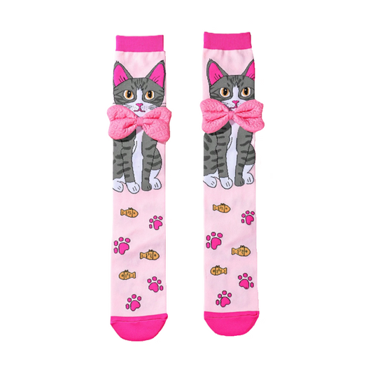 Pair of socks with a cat design and pink bow on a pink background