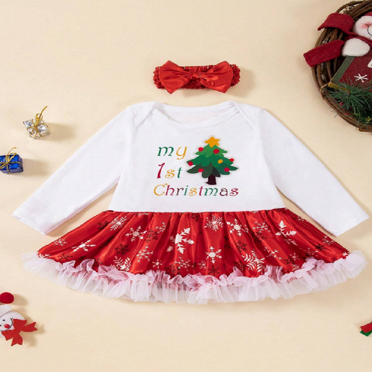 Baby outfit with red and white skirt and 'my 1st Christmas' text on a beige background