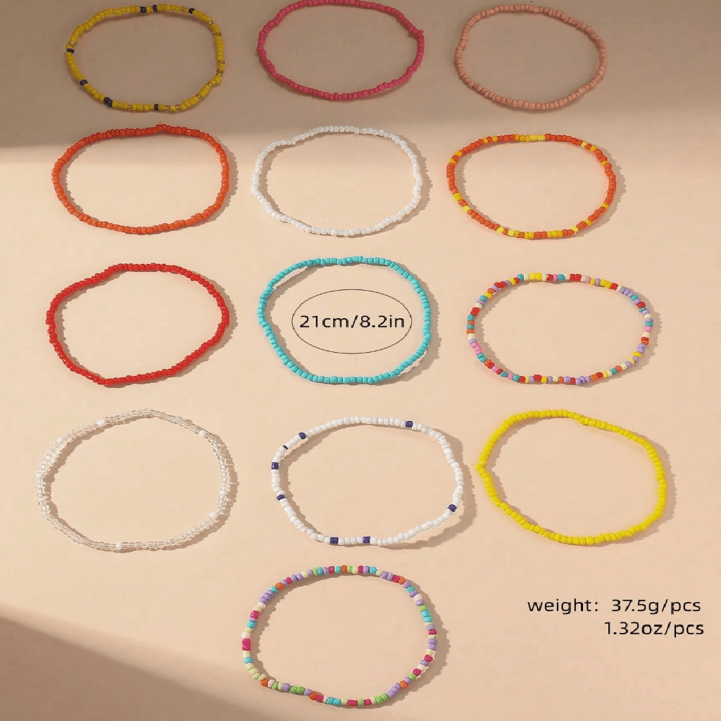 Colorful beaded anklets on a foot with a sandy background