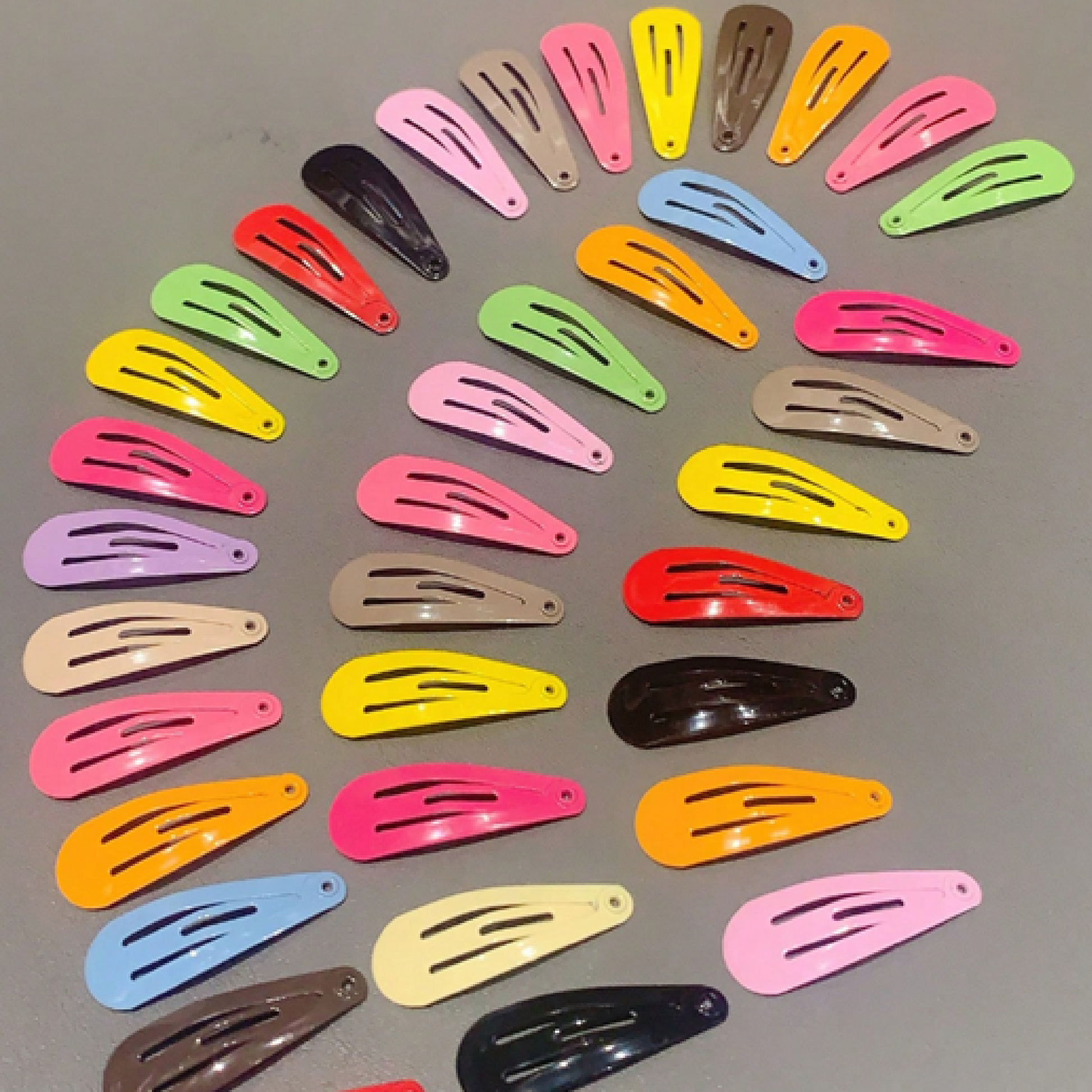 A collection of colorful hair clips in various shades arranged neatly on a surface.