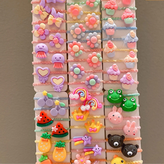 A collection of twisted hair ties in assorted colors with various cute designs such as animals and fruits.