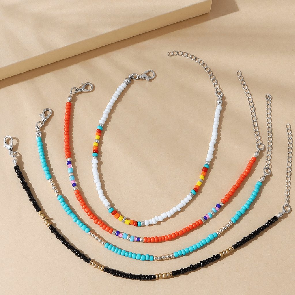 Set of beaded necklaces on a beige background