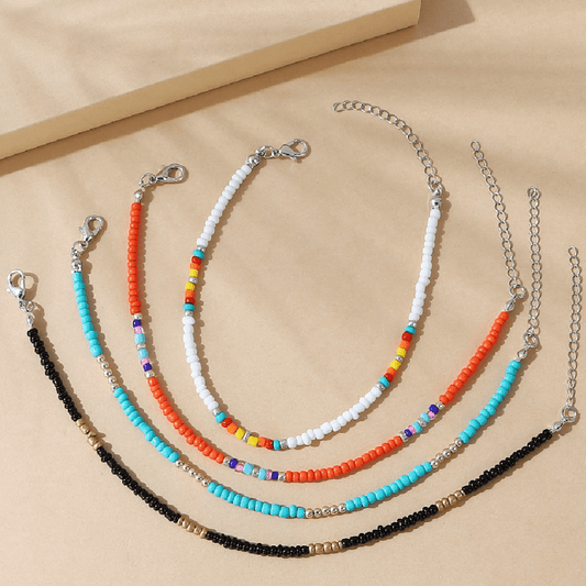 Set of beaded necklaces on a beige background