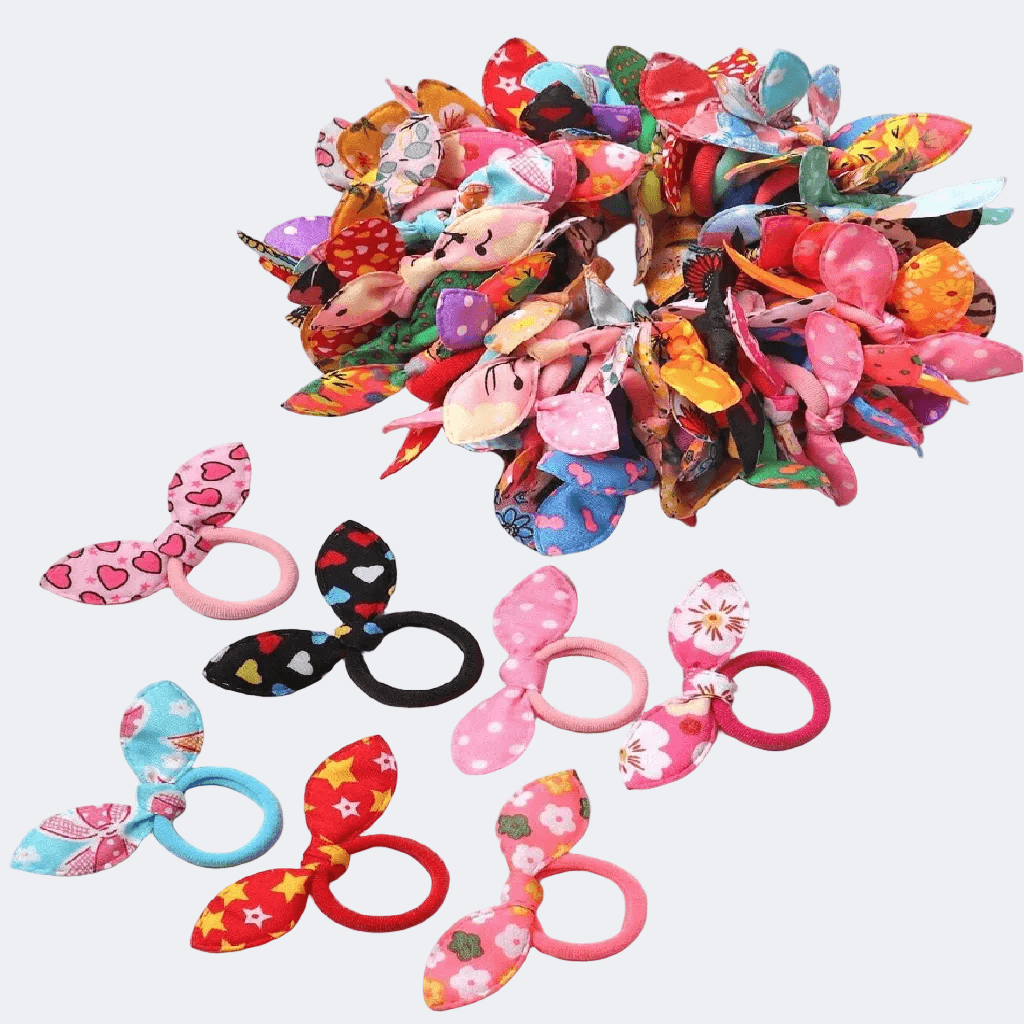 Colorful hair ties with decorative bows on a white background