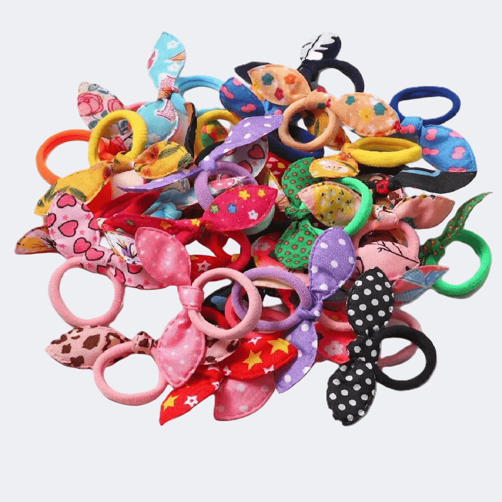Colorful assortment of hair ties and bows on a white background