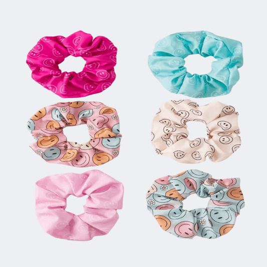 Set of six colorful scrunchies on a white background