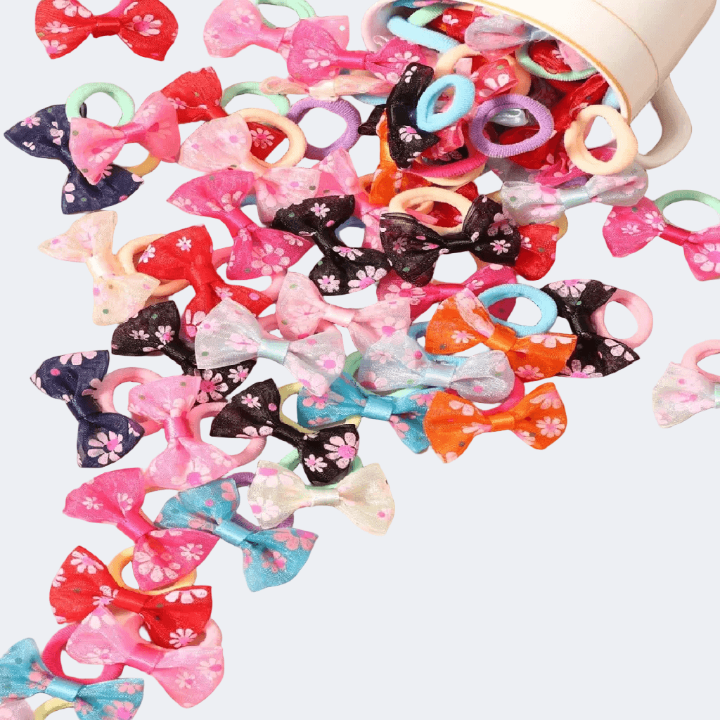 Colorful hair bows and rubber bands scattered on a white background
