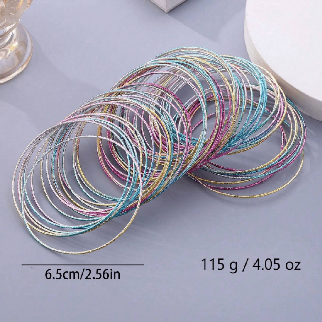 A pile of thin metallic bangles or hair ties in multiple pastel colors, including silver, gold, pink, blue, and purple, arranged on a light gray surface. White text at the bottom reads 6.