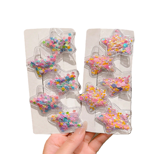 Star-shaped candy molds with colorful sprinkles held by a hand against a white background