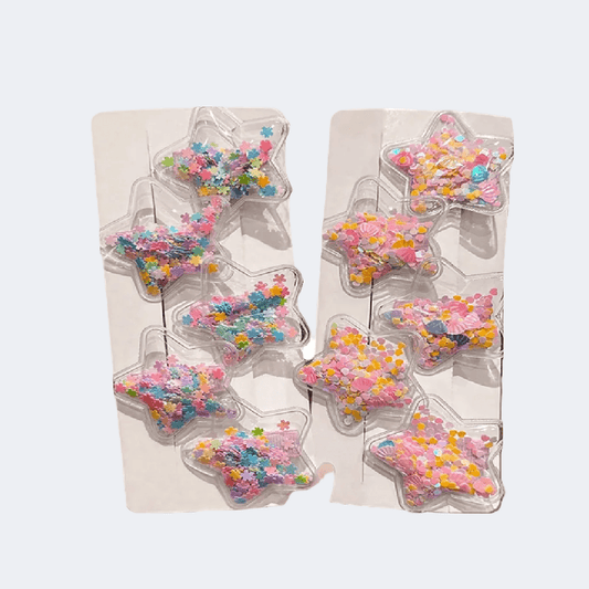 Star-shaped candy molds with colorful sprinkles on a light background