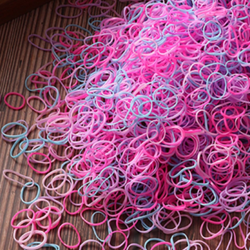 A collection of colorful disposable hair ties in neon pop colors scattered on a surface.