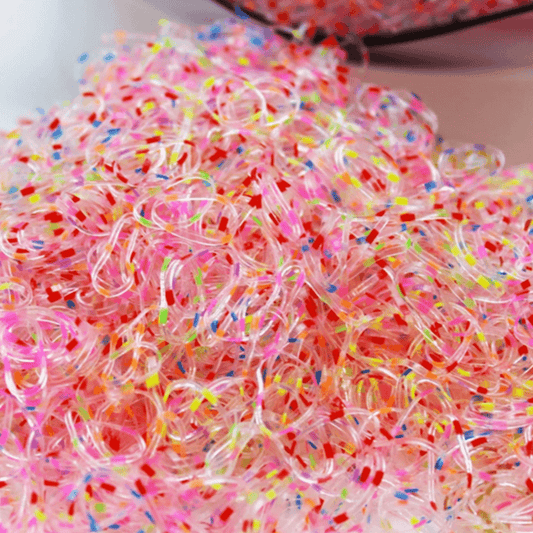 Colorful rubber bands with sprinkles on a white background