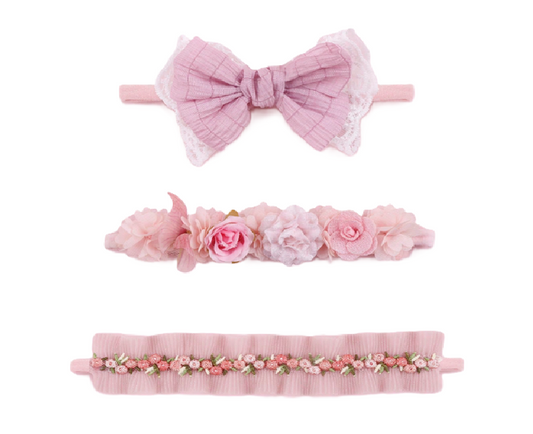 Set of three pink headbands with floral and bow designs
