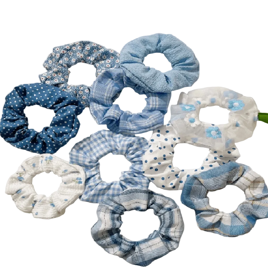 Set of blue and white patterned scrunchies on a light gray background