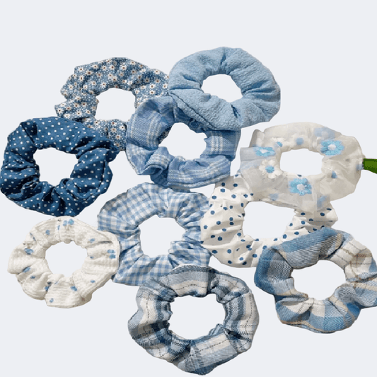 Set of blue and white patterned scrunchies on a light gray background