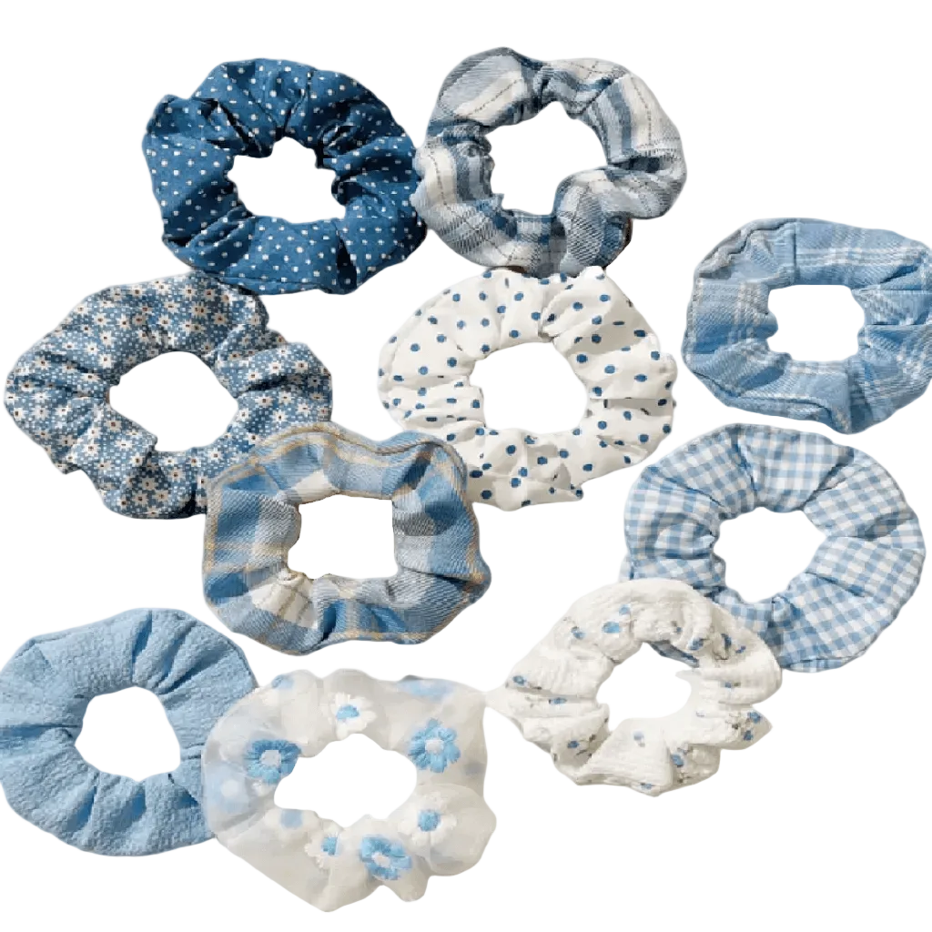 Collection of blue and white scrunchies with various patterns on a light gray background