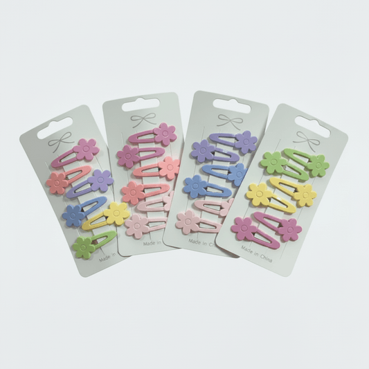 Set of colorful hair clips on their packaging with a white background