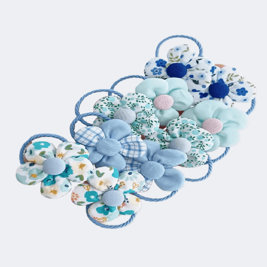 Collection of blue floral and checkered hair ties on a white background