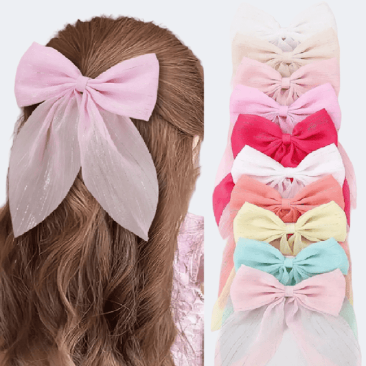 Pink hair bow on a person's head with a row of colorful hair bows below.