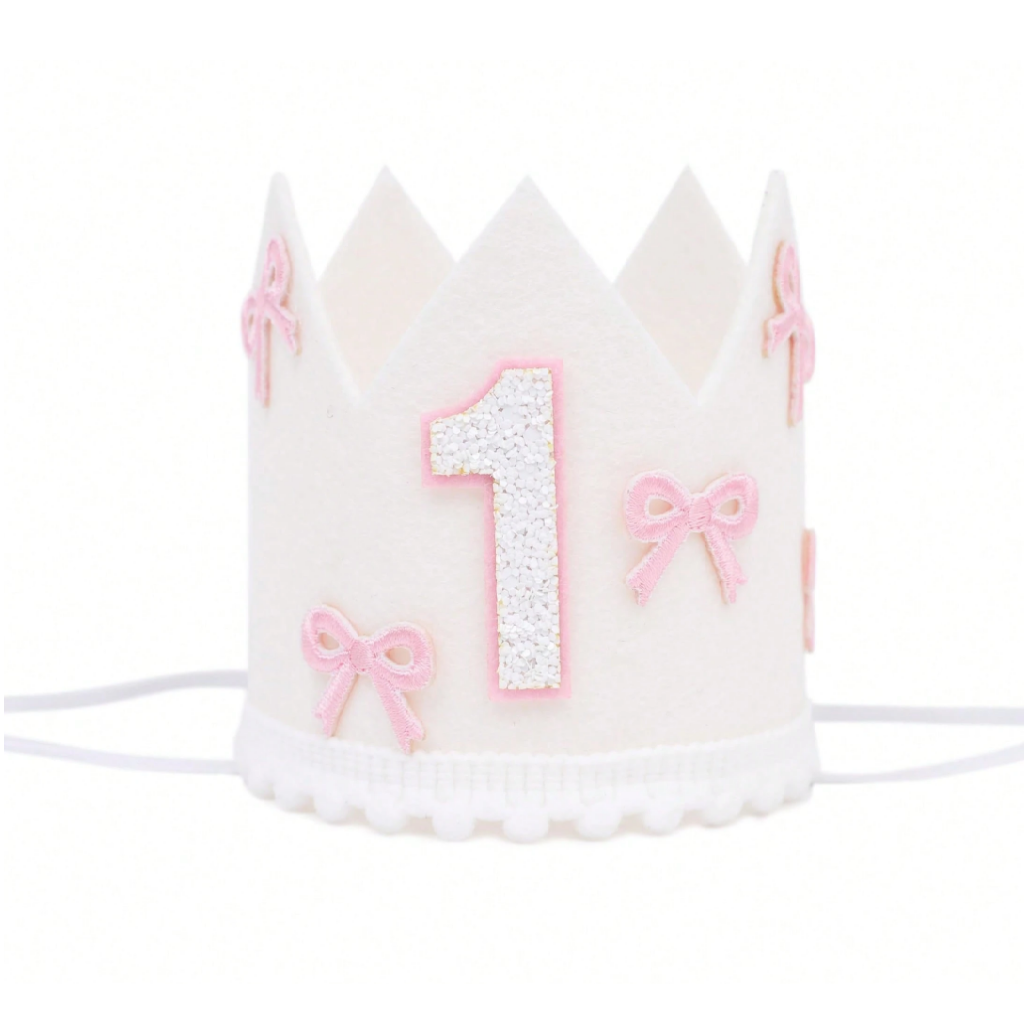 White birthday crown with pink number '1' and bows on a white background