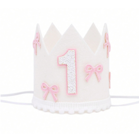 White birthday crown with pink number '1' and bows on a white background