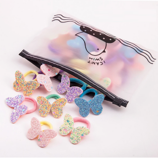 Colorful butterfly-shaped hair ties with a black clip on a white background