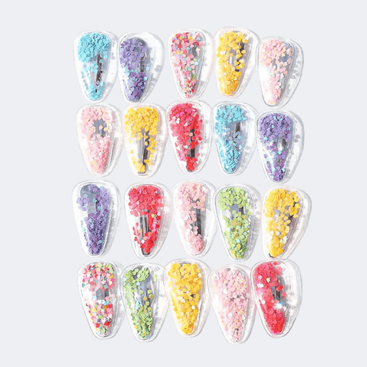 Set of colorful hair clips with decorative elements on a white background