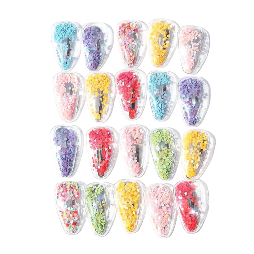 Set of colorful hair clips with decorative elements on a white background