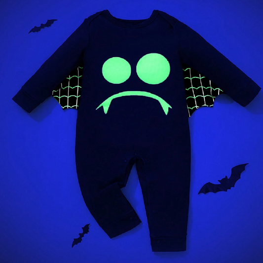 Black baby onesie with green glowing design on a blue background