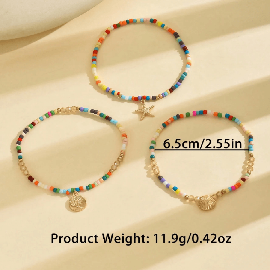 Anchors bracelet on a foot against a sandy background
