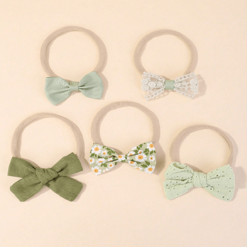 Set of five hair bows on beige background