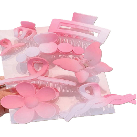 Set of pink hair accessories including clips and barrettes in a clear packaging.