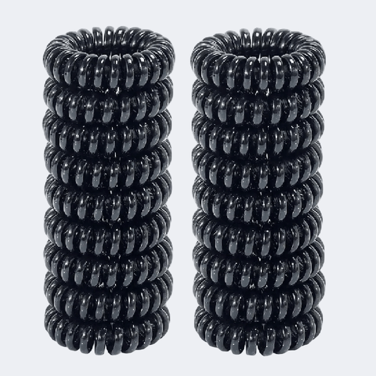 Two black spiral hair ties on a white background