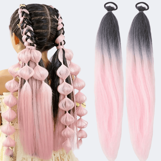 Pink and black ombre hair extensions with a styled braid on a white background