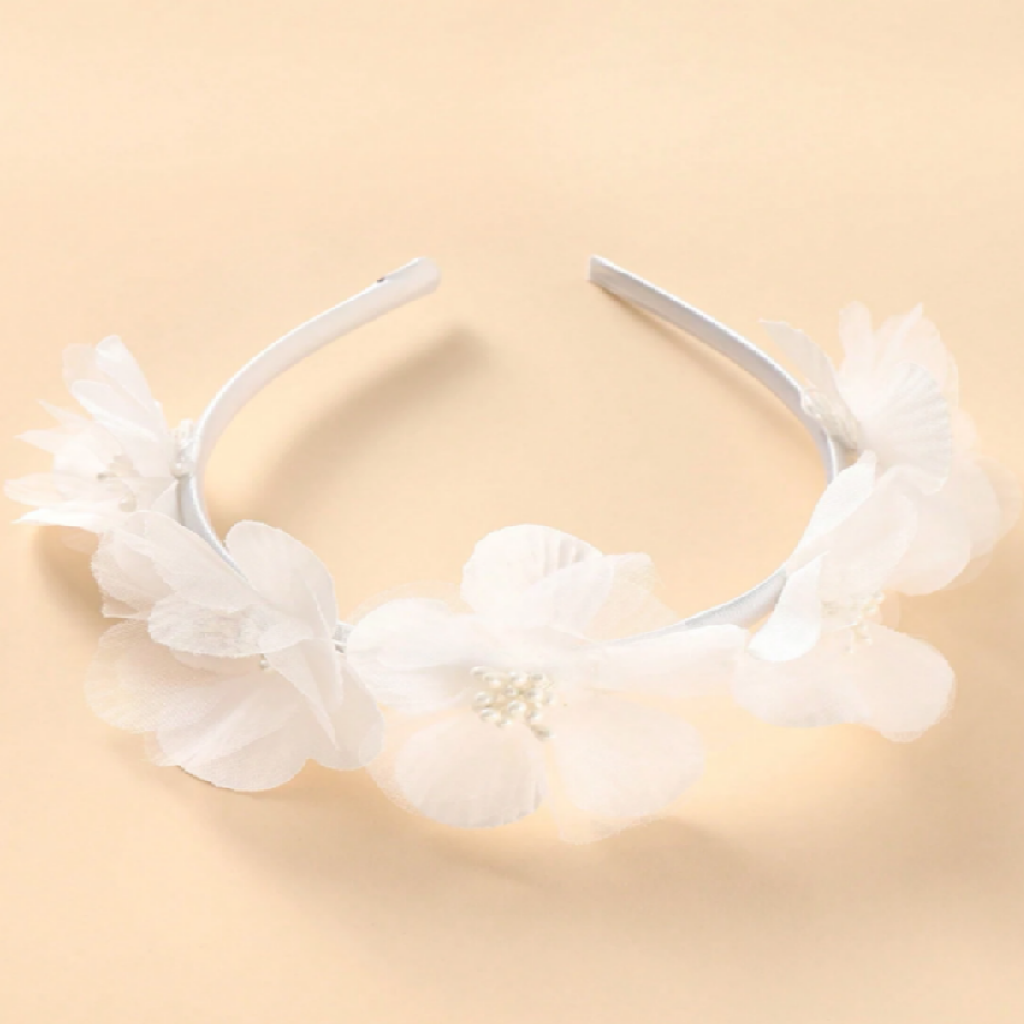 White floral headband on a beige background