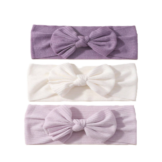 Three headbands with bow designs in purple, white, and light purple on a white background.