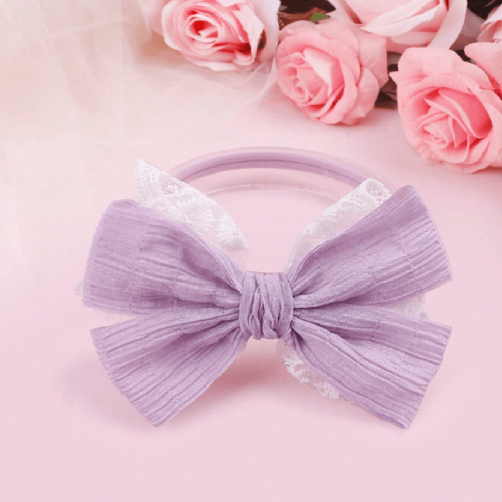 Purple headband with floral decorations on a pink background