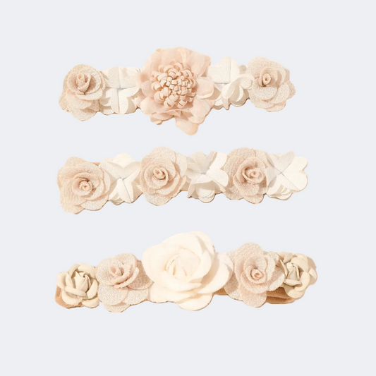Set of three floral headbands with beige and white flowers on a white background
