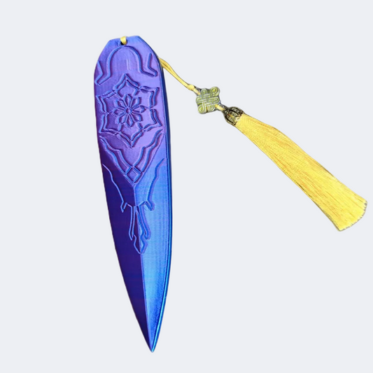 Blue decorative object with a yellow tassel on a white background