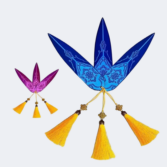 Decorative blue leaf-shaped item with yellow tassels on a white background
