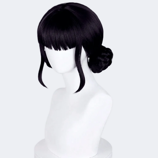 Black wig styled with a bun on a white mannequin head against a white background
