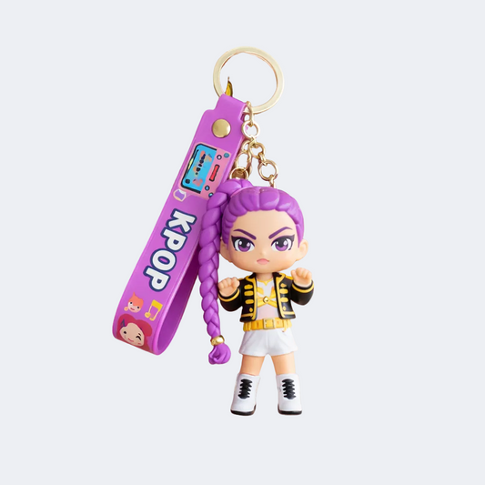Keychain with a character and purple strap labeled 'KPOP' held by a hand on a white background