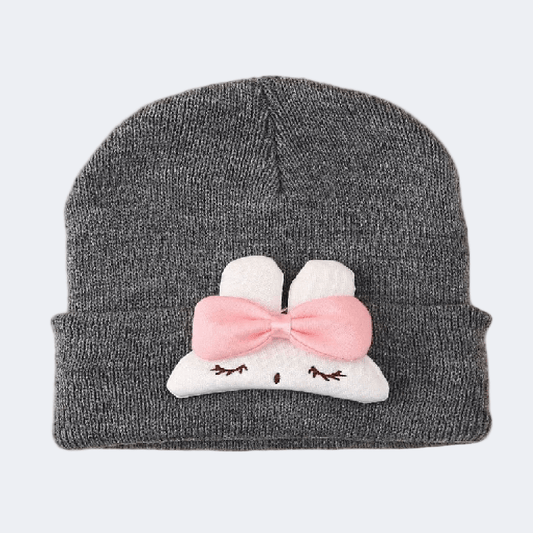 Gray knit beanie with a cartoon cloud design featuring a pink bow on a light gray background