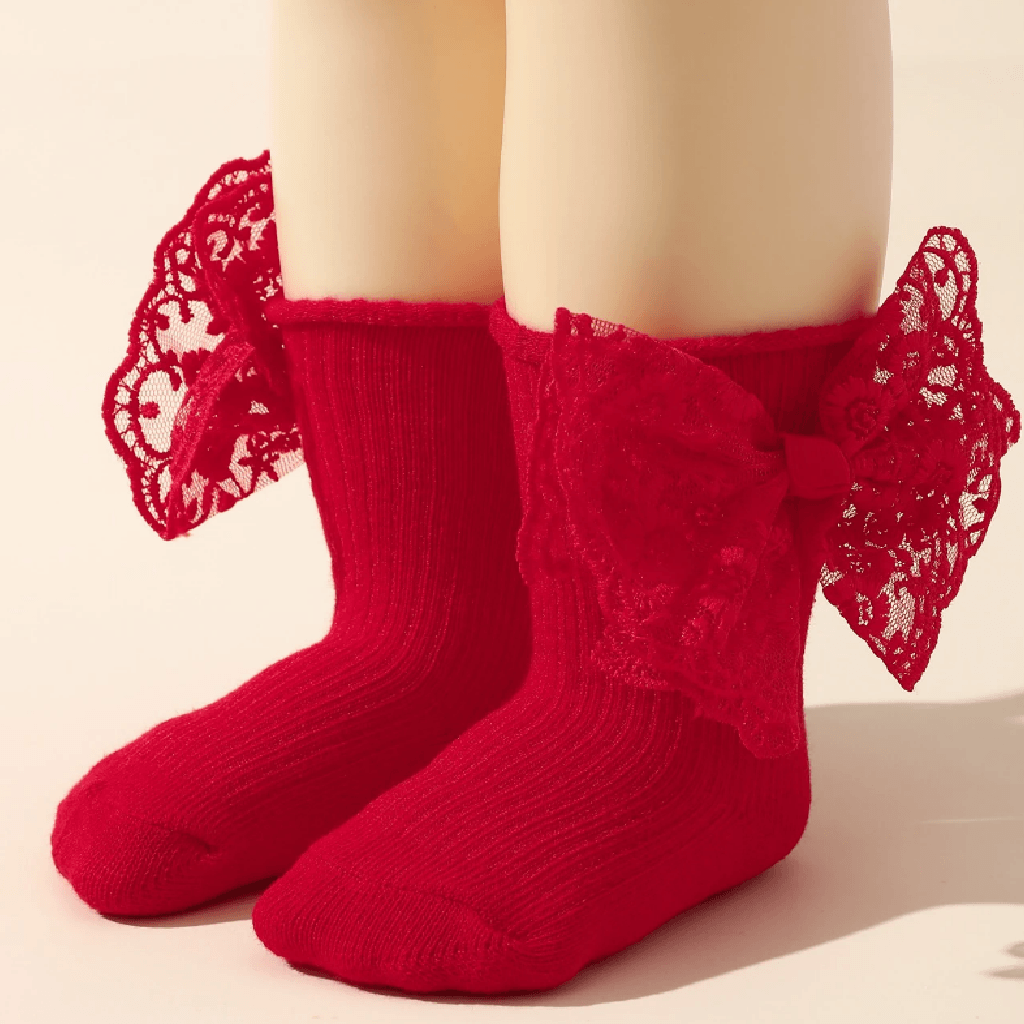 Red socks with lace details on a neutral background