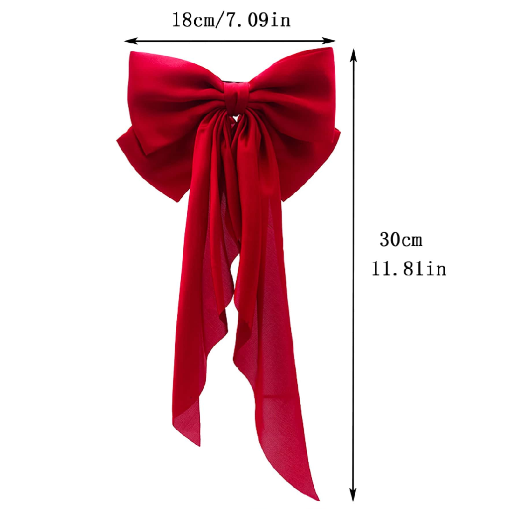 Person with long dark hair wearing a large red bow in the back on a white background